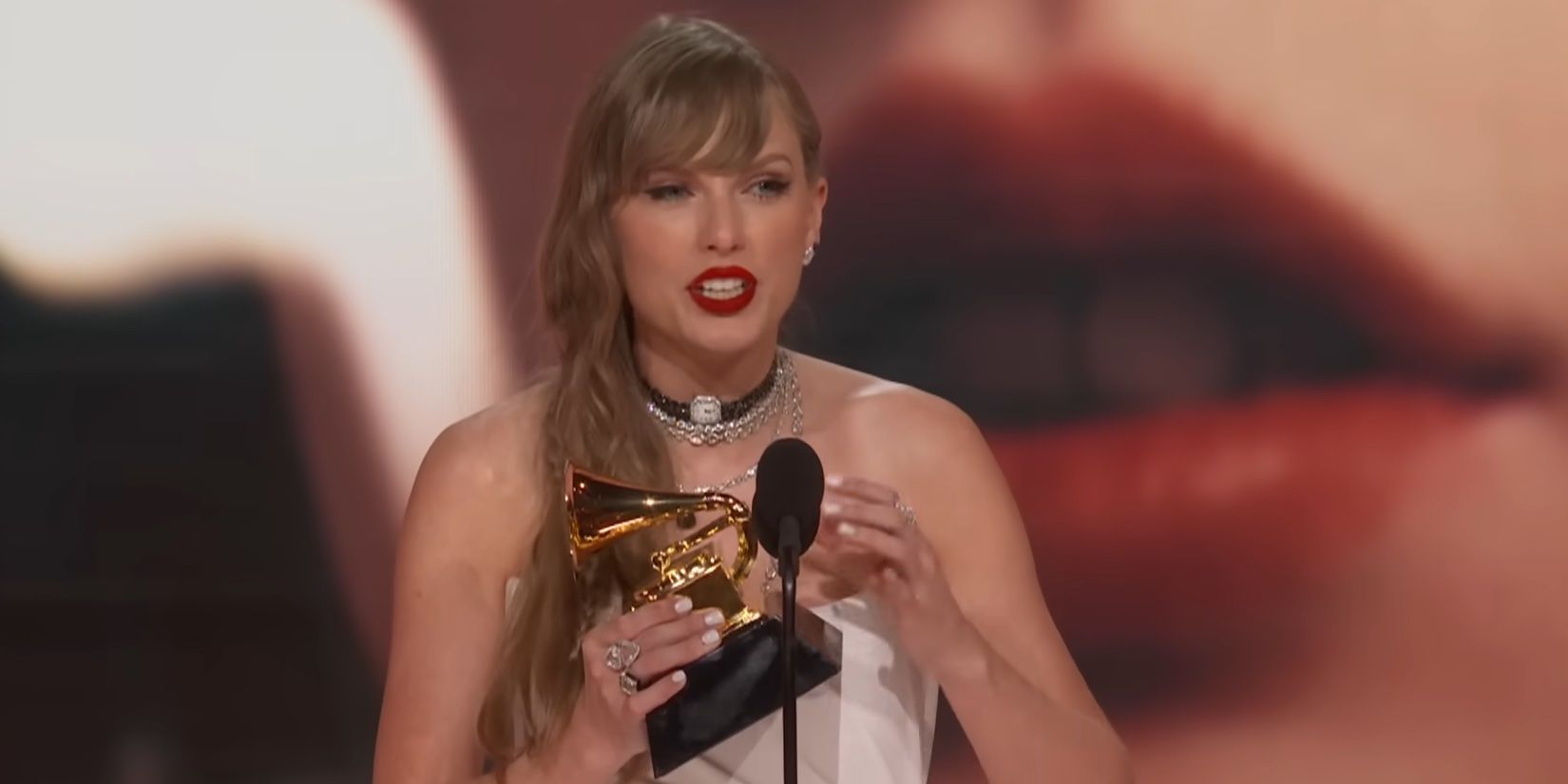 Taylor Swift accepting her award for Album of the Year for Midnights at the 2024 Grammys.