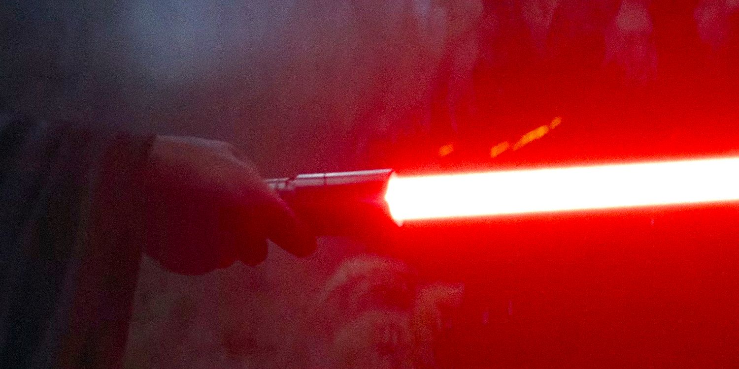 A hand holding a red lightsaber from The Acolyte