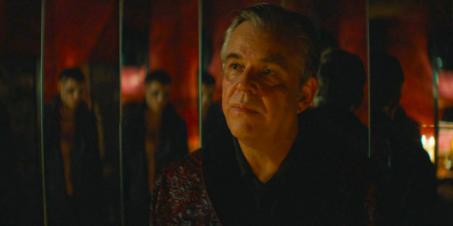 Danny Huston looking serious, with the reflection of Eric Draven in the mirror behind him in The Crow