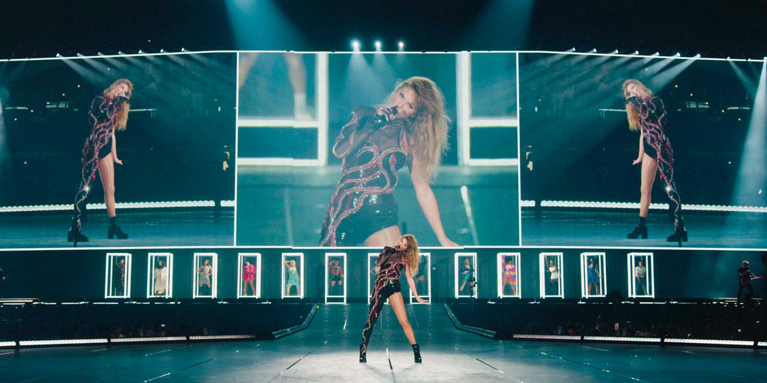 Wide shot of Taylor Swift on stage with screens behind her, representing the Reputation era of the Eras Tour