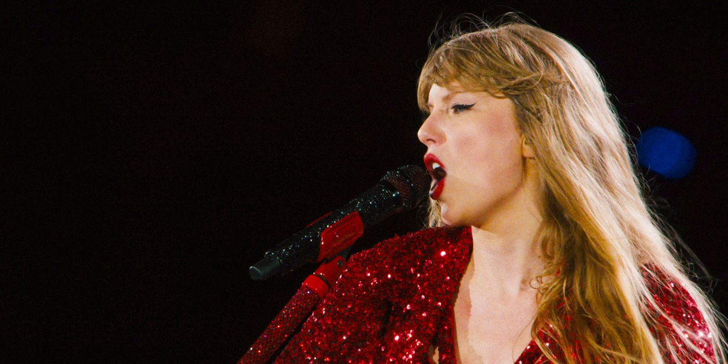 Close-up of Taylor Swift singing in a shiny red outfit from the Eras Tour