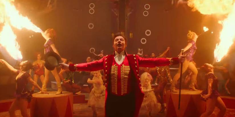 The explosive opening in in The Greatest Showman, featuring PT Barnum (Hugh Jackman) in a red circus outfit, singing with his arms outstretched