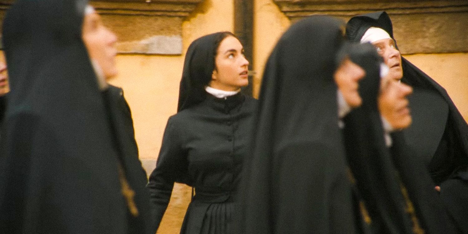 A group of nuns in the orphanage courtyard looking upwards in The First Omen