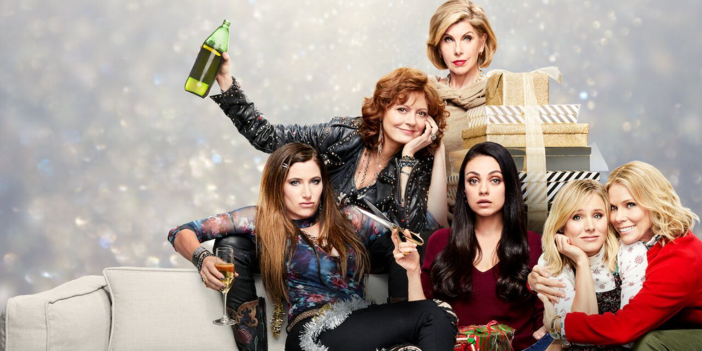 The main cast of A Bad Moms Christmas sitting on a couch in various poses.