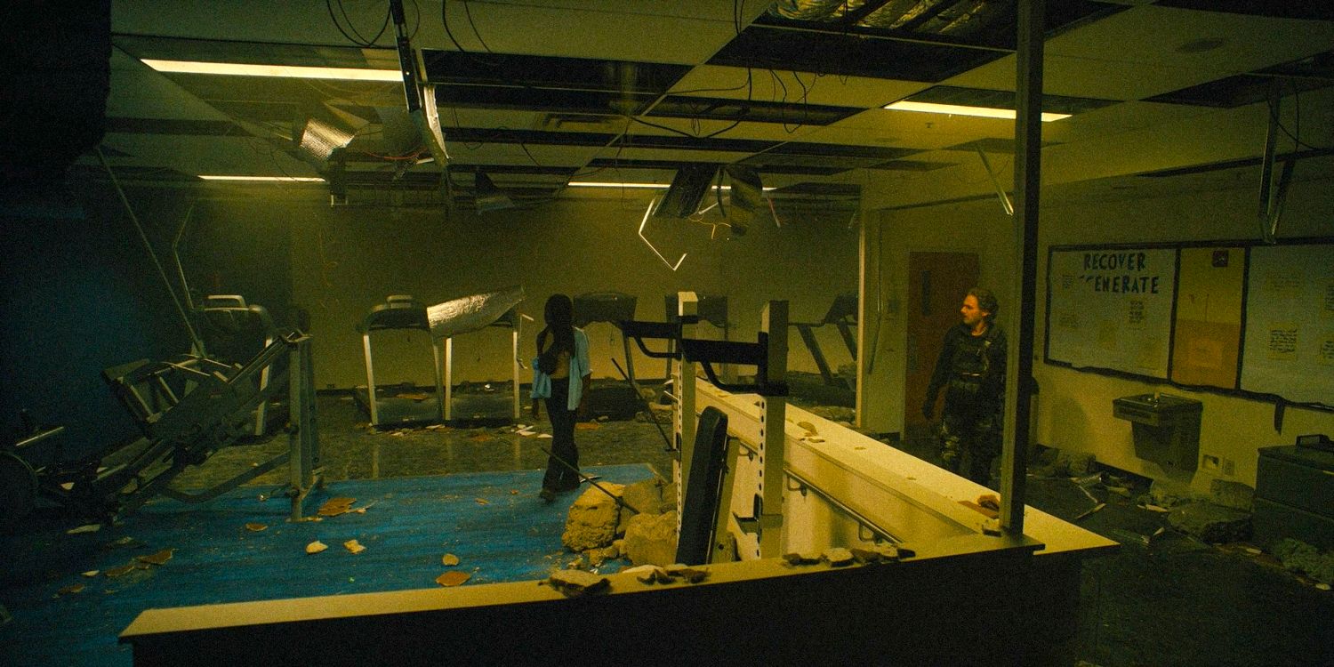 Rick Grimes and Michonne Hawthorne exploring what appears to be a destroyed gym in The Walking Dead: The Ones Who Live.