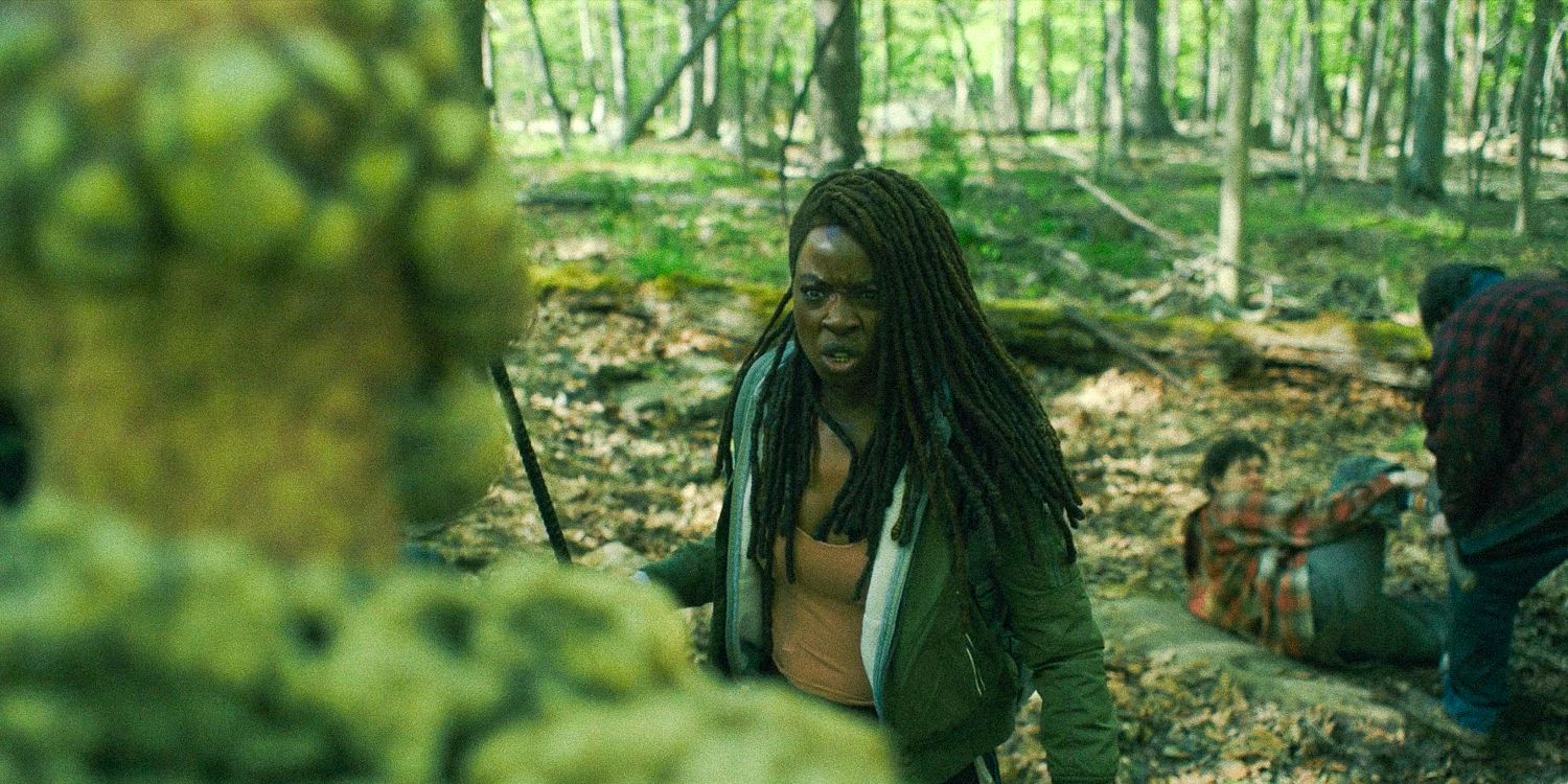 Michonne Hawthorne facing a stone walker in the middle of the forest in The Walking Dead: The Ones Who Live
