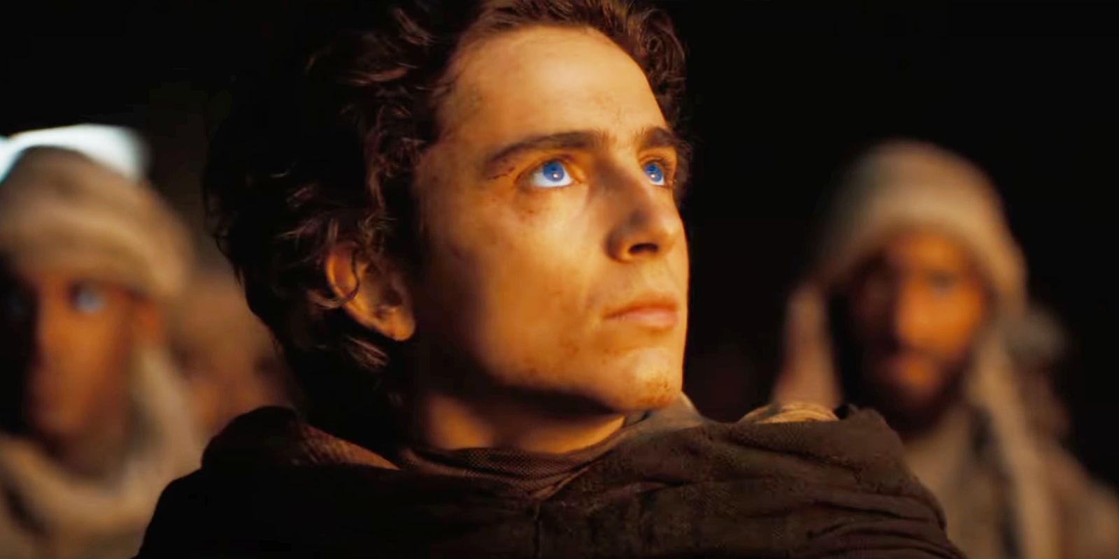 Timothée Chalamet as Paul Atreides looking up with blue eyes in Dune: Part Two