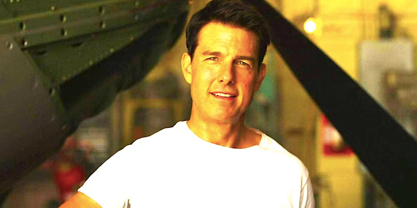 Tom Cruise's Maverick smiling while working on a plane in Top Gun: Maverick's ending