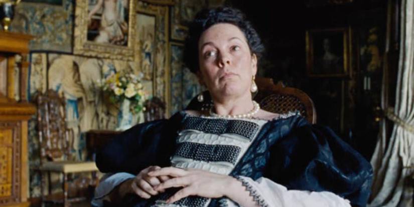 Olivia Colman as Queen Anne sitting down in The Favourite