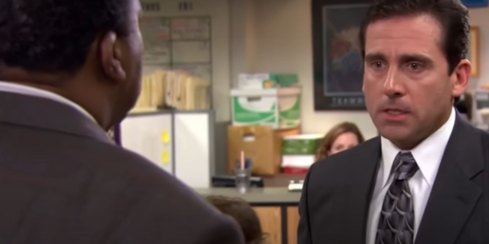 Steve Carell as Michael Scott looking annoyed as he speaks to Stanley in The Office