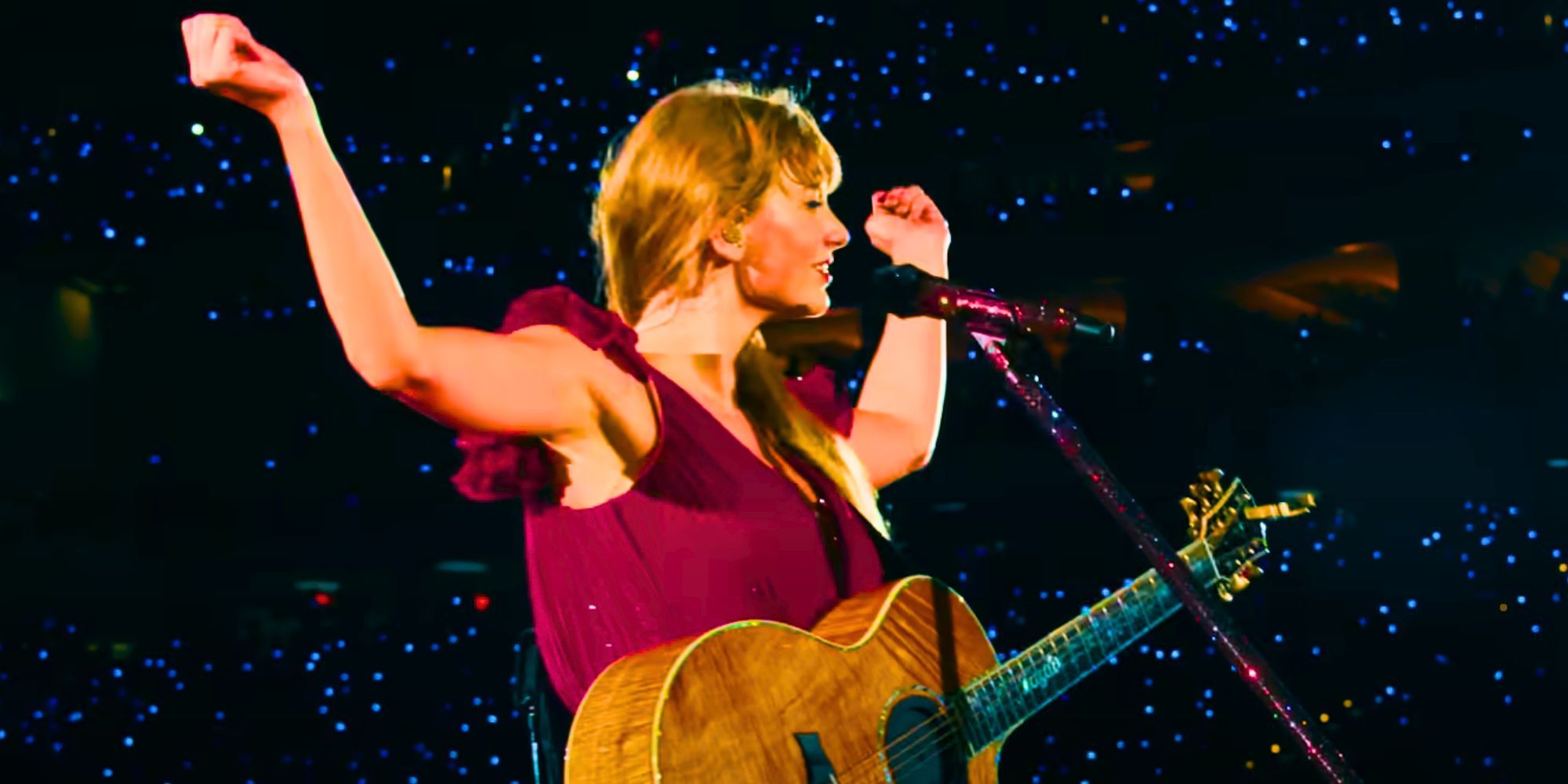 Taylor Swift with an acoustic guitar in the Taylor Swift: The Eras Tour trailer