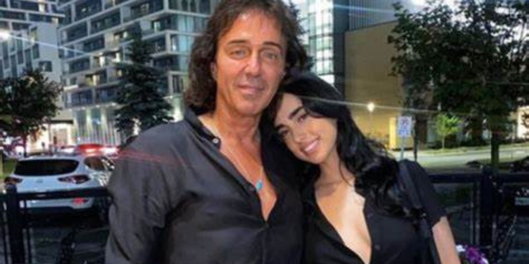 The bachelor 28 maria georgas and father nick georgas posing arm in arm at night in front of a building