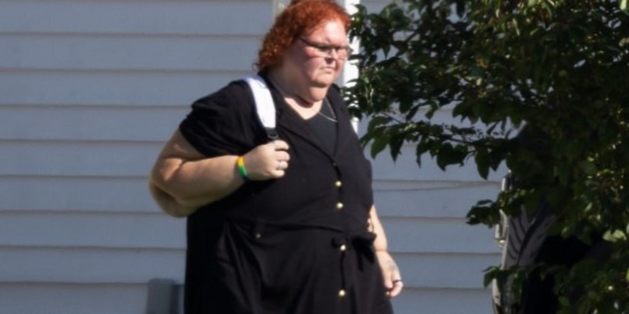 1000-lb Sisters Tammy Slaton in black dress, walking outside