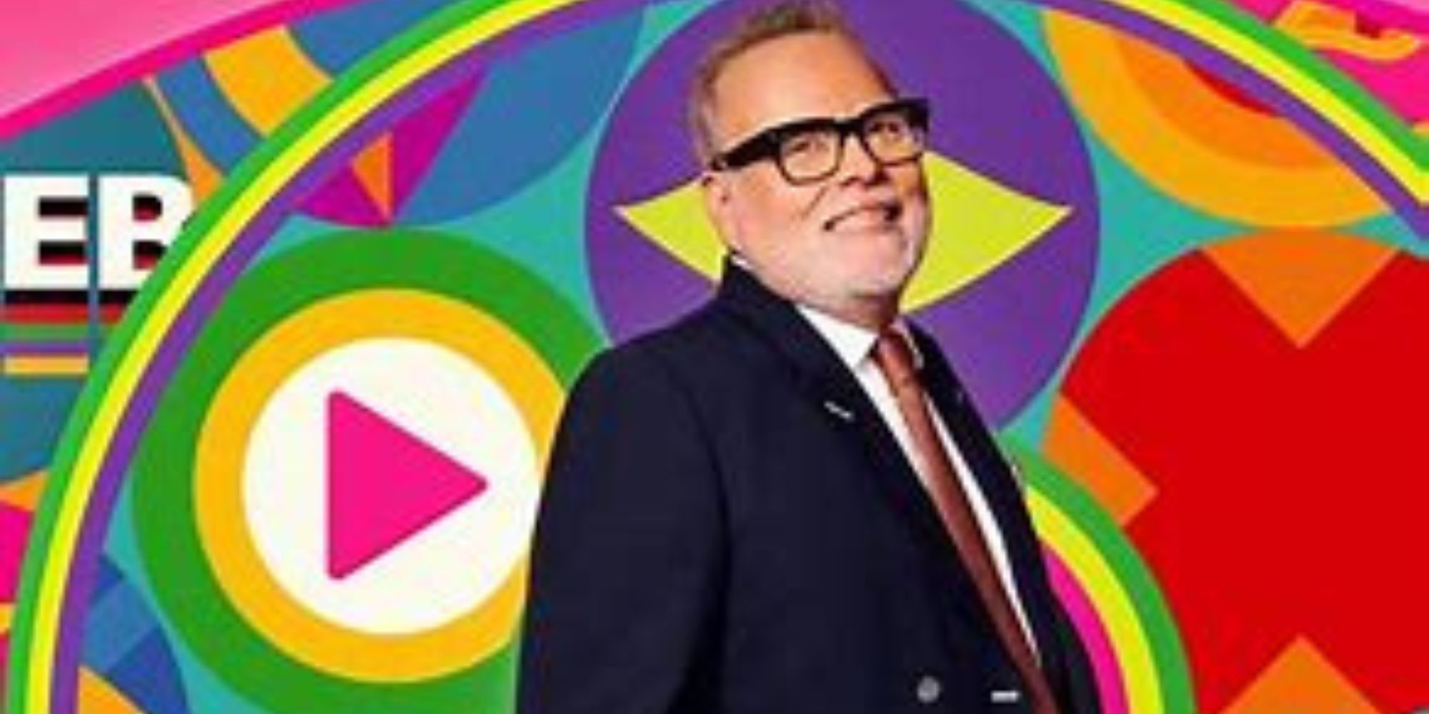 Celebrity Big Brother UK Gary Goldsmith in a suit against a colorful background