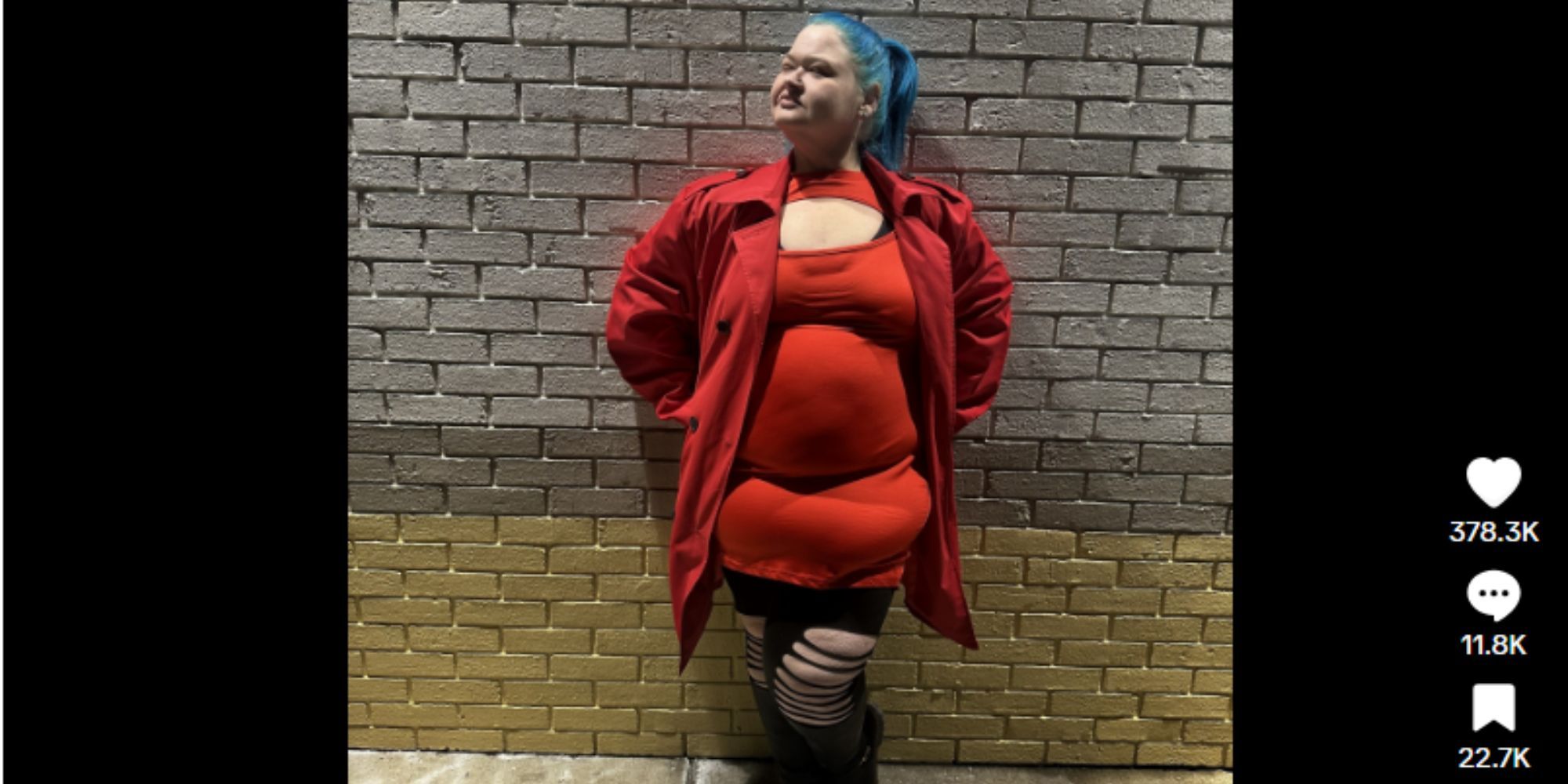 1000-lb sisters amy slaton in red, leaning back against a brick wall