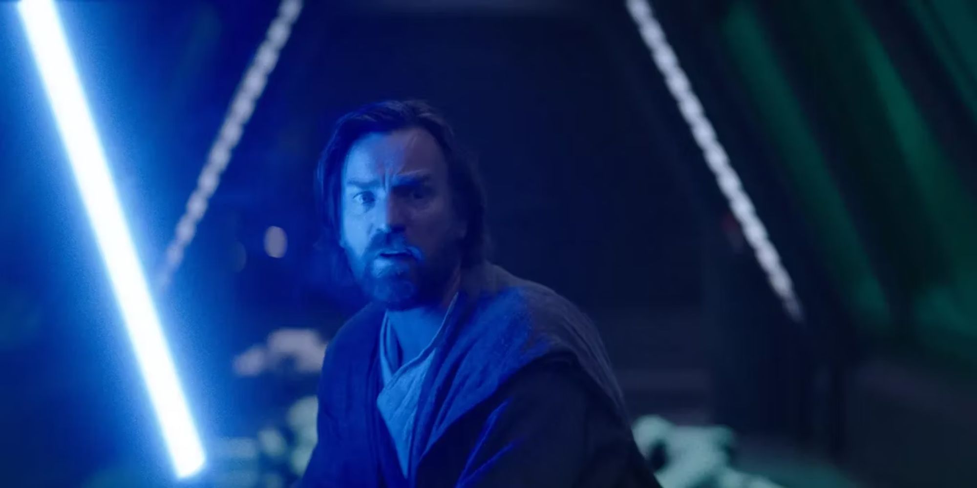 Ewan McGregor as Obi-Wan Kenobi looking scared and holding his lightsaber