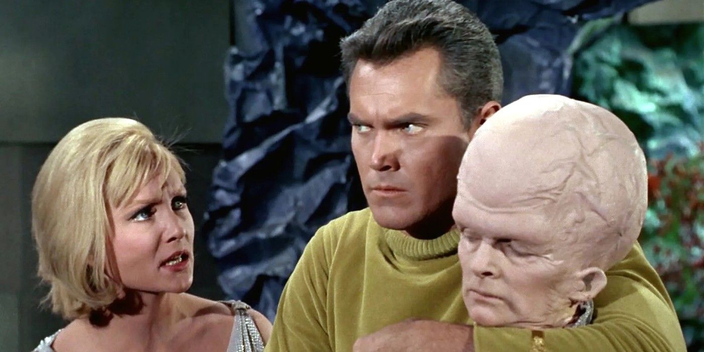 Vina speaks urgently to Captain Pike as he holds a Talosian in the Star Trek: TOS unaired pilot episode "The Cage"