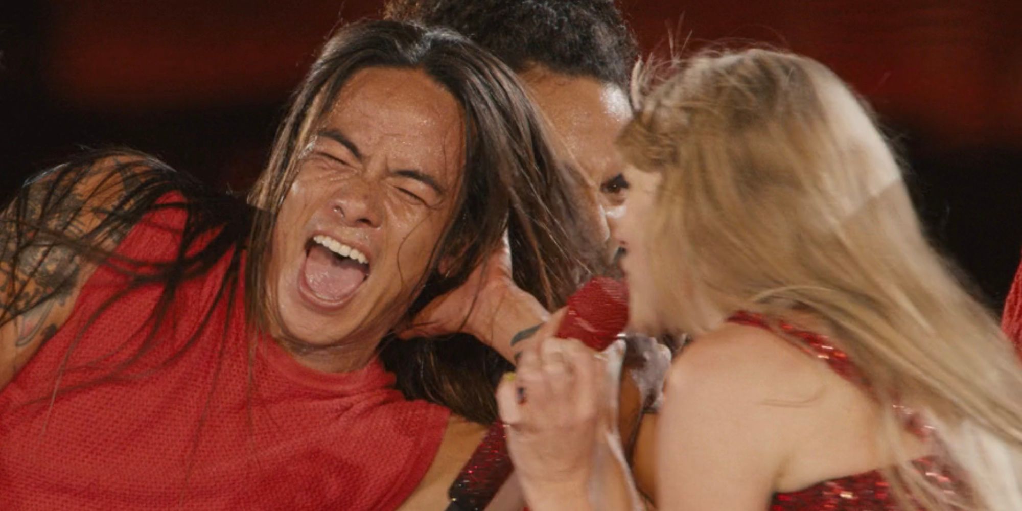 Dancer Whyley Keolaokalani Yoshimura smiling while Taylor Swift sings in Taylor Swift: The Eras Tour
