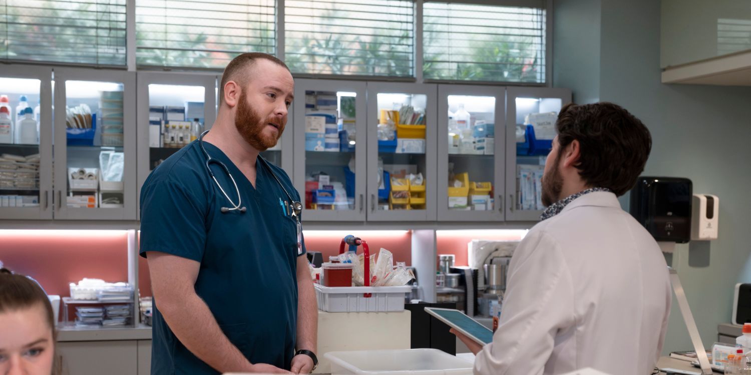 The Good Doctor's Jerome stands by the nurses station facing Asher and talking to him