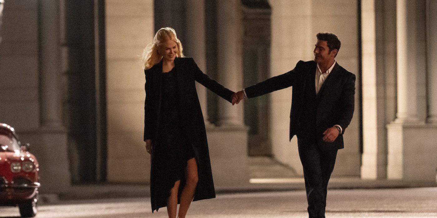 Nicole Kidman and Zac Efron standing on a street holding hands in A Family Affair