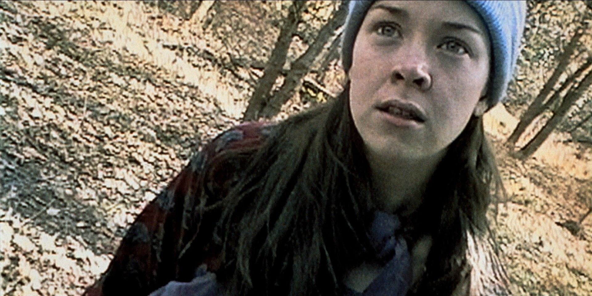 a girl in the woods looking nervous in The Blair Witch Project