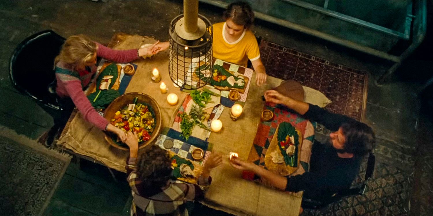 Aerial shot of the Abbott family holding hands before dinner in A Quiet Place- Day One Official trailer