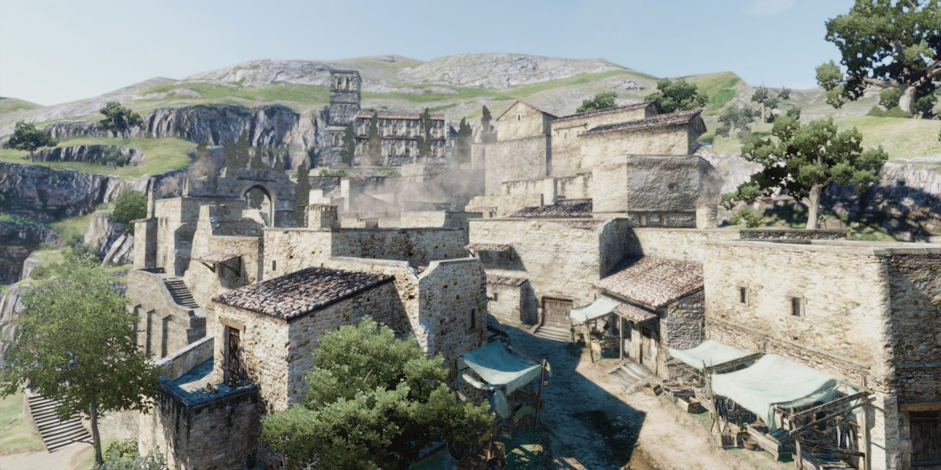 A vista of the Mediterranean-inspired city of Cassardis, showing stone buildings set against rocky hills, in a screenshot from Dragon's Dogma.