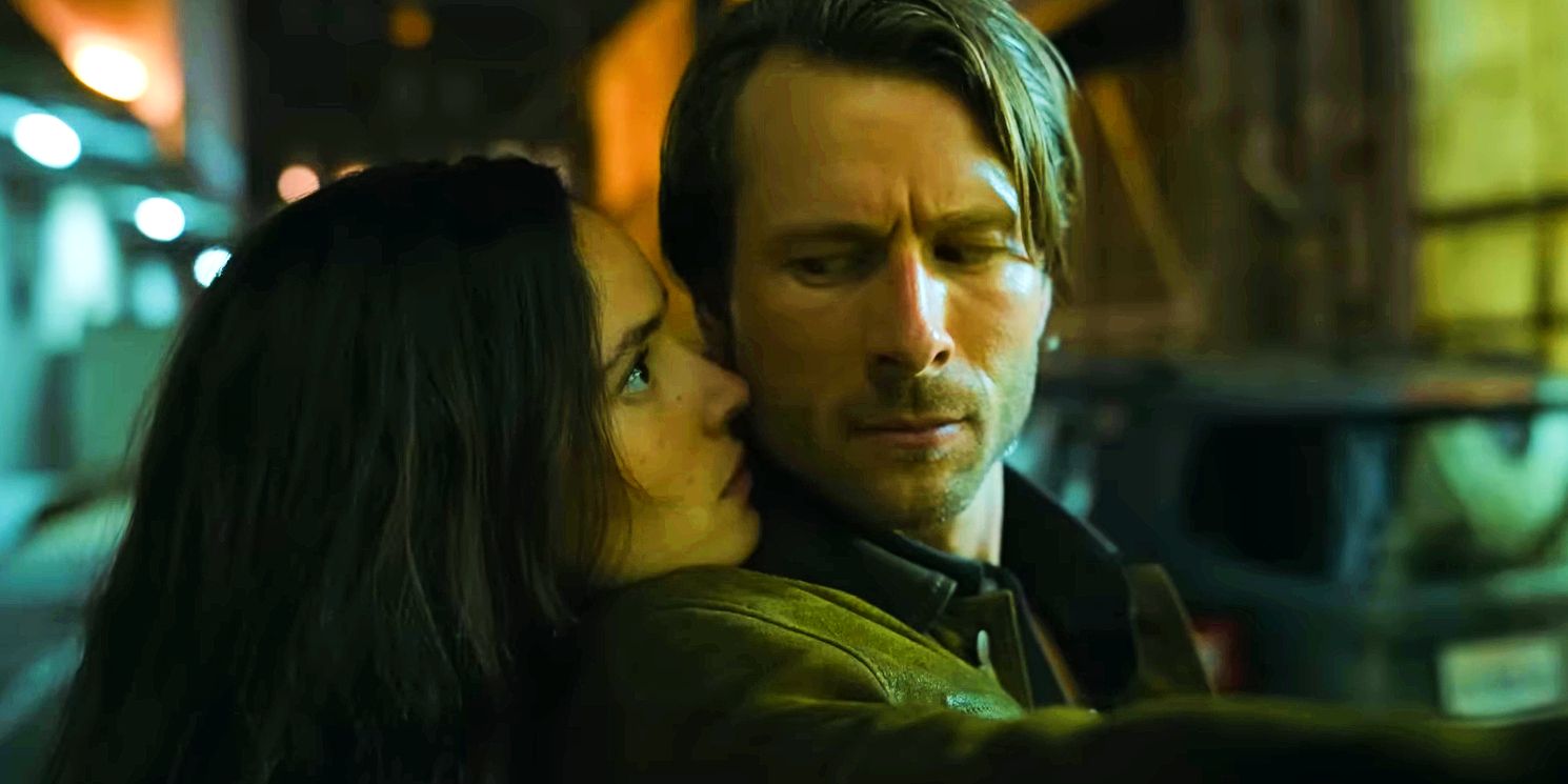 Adria Arjona and Glen Powell look nervously at each other in Hit Man