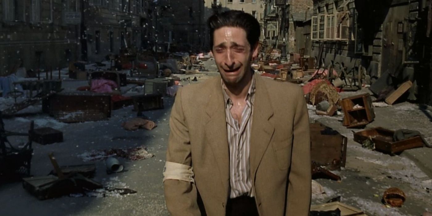 Adrien Brody weeping as he walks down a war-torn street in The Pianist