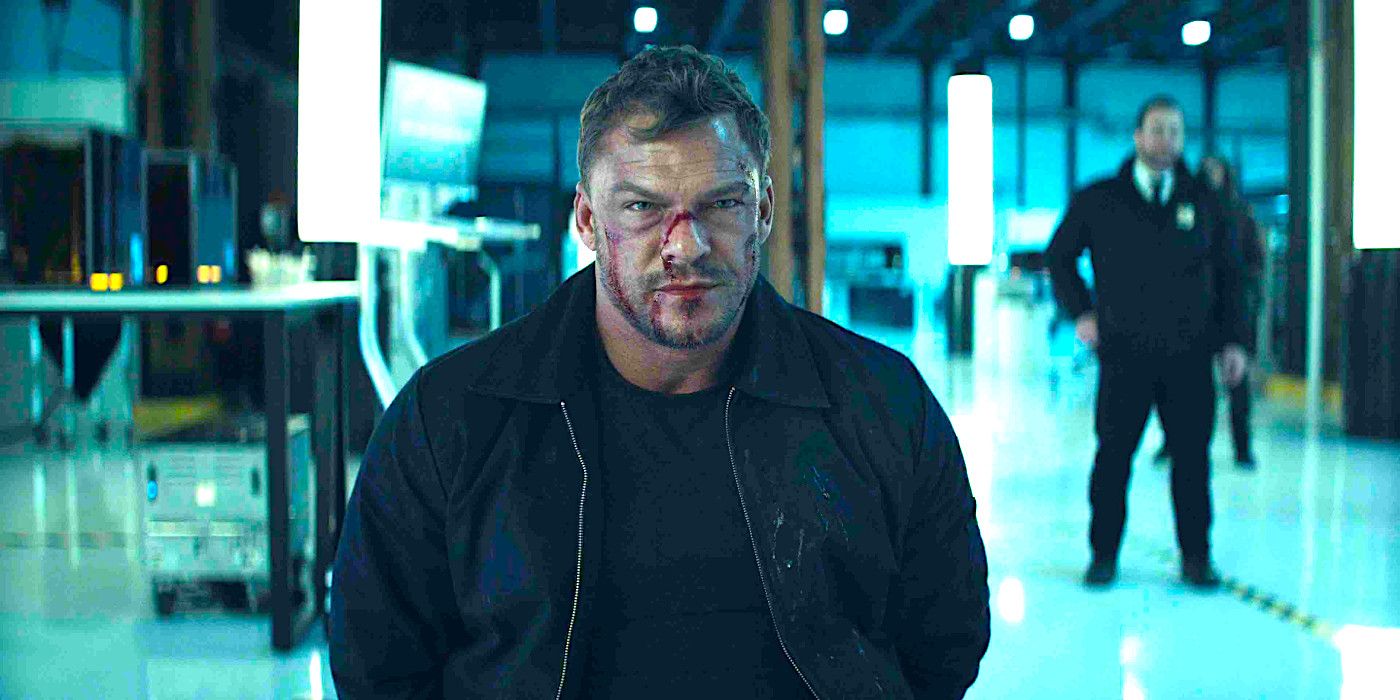 Alan Ritchson glares menacingly, his face bloodied, in a scene from Reacher season 2