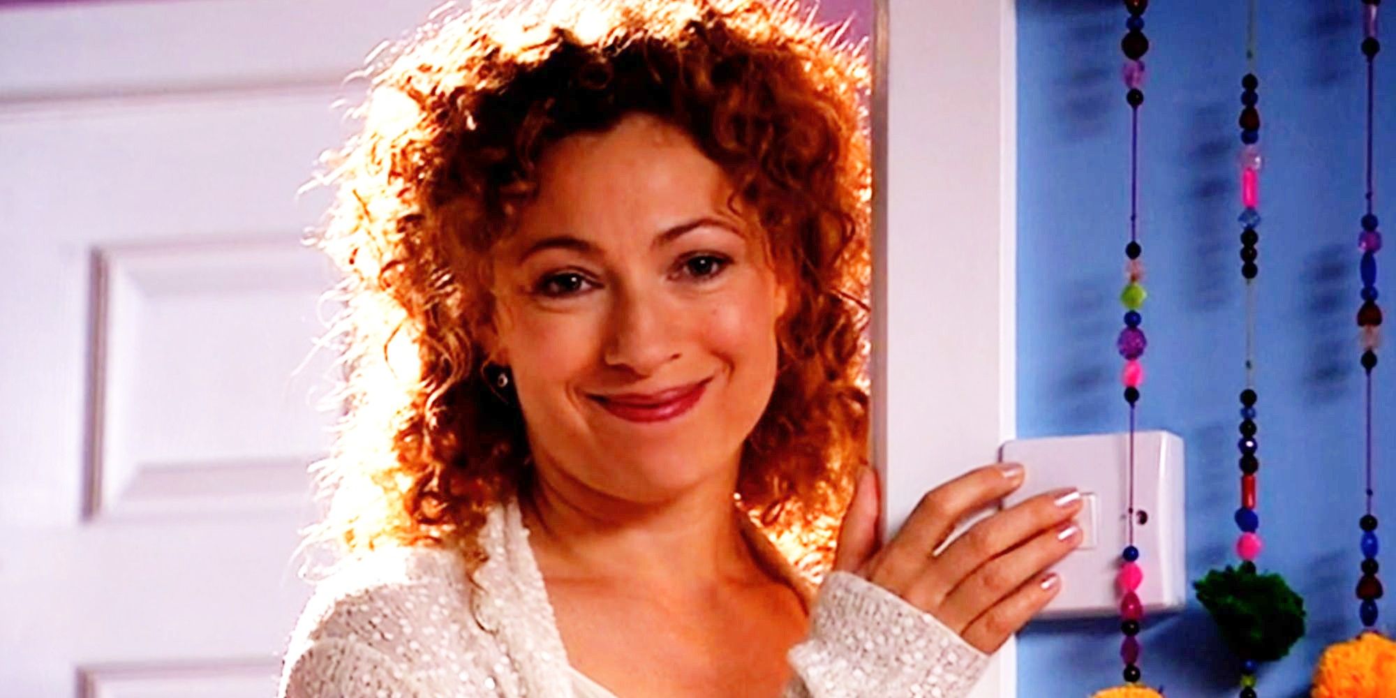 Alex Kingston as River Song smiling In Doctor Who's Forest of the Dead