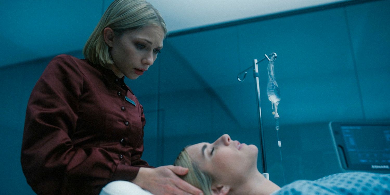 Cora holds Anna's head and watches her while she is lying down in American Horror Story: Delicate season 12 Ep 8