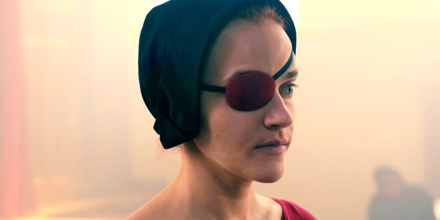 An image of Janine (Madeline Brewer) wearing her red eye patch and looking serious in The Handmaids Tale