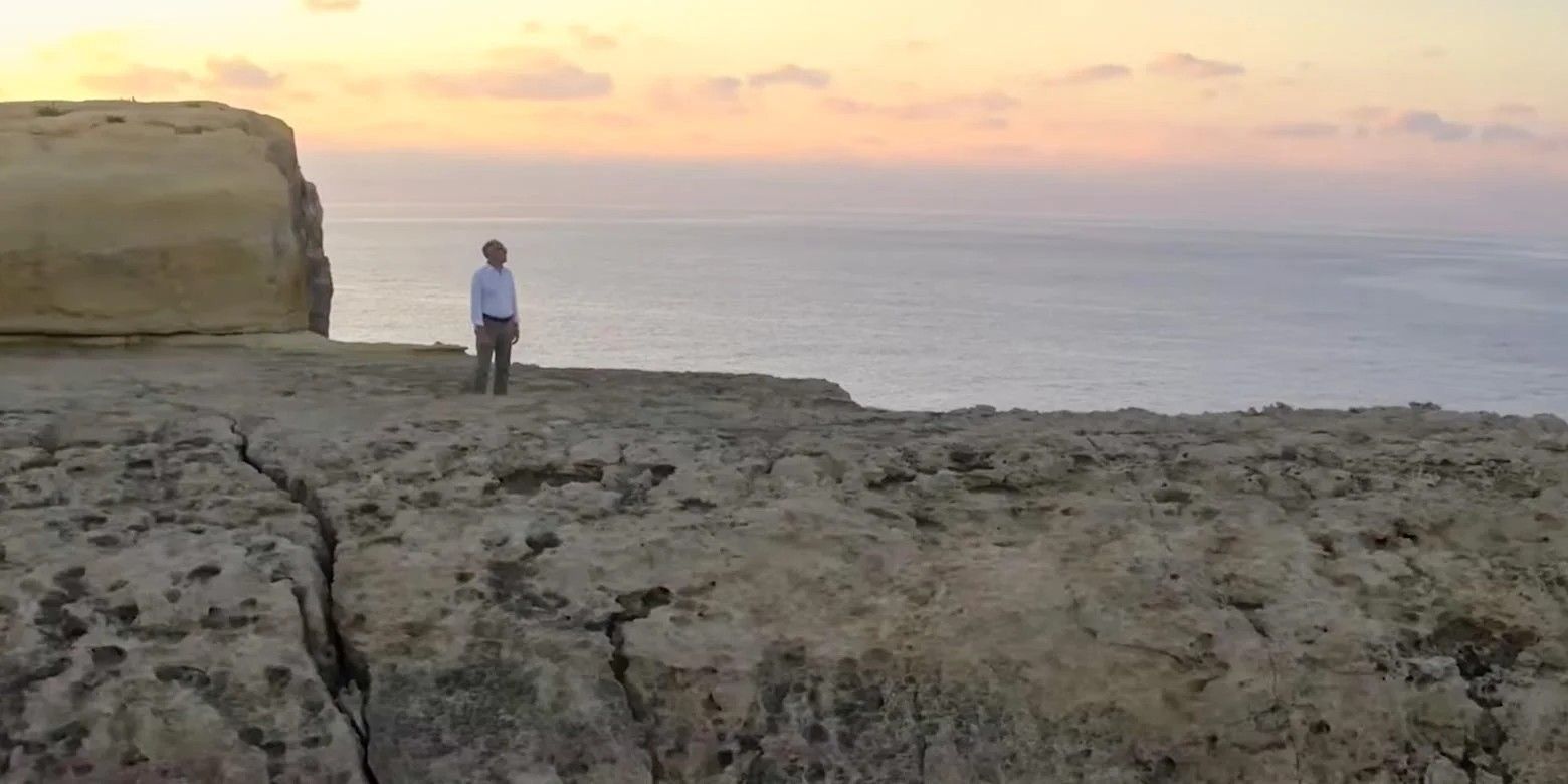 Ancient Apocalypse on Netflix with Graham Hancock standing on a cliff side