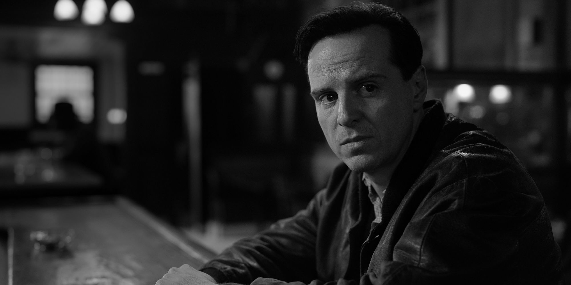 Andrew Scott as Tom Ripley, sitting in a bar in the Ripley series