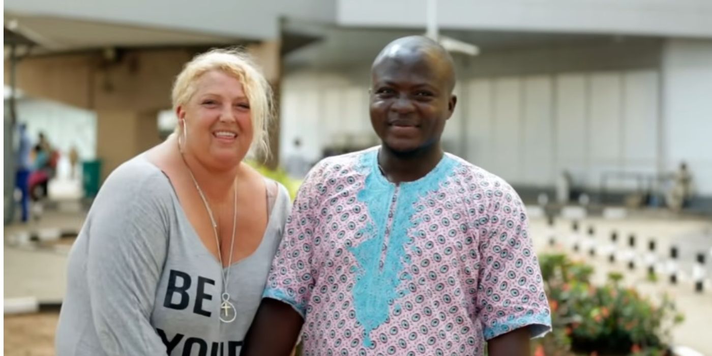 Angela Deem With Michael Ilesanmi In 90 Day Fiance standing side by side laughing in Nigeria