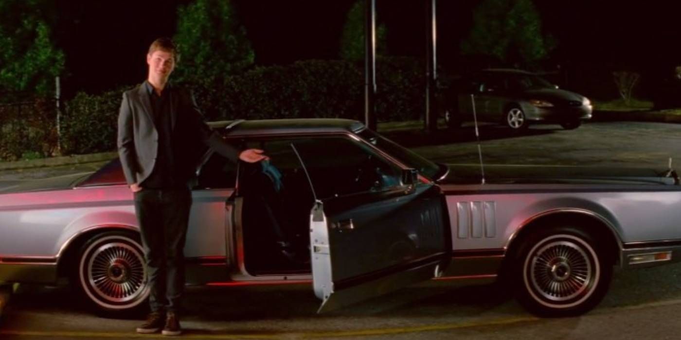 Ansel Elgort as Baby in Baby Driver standing in front of 1979 Lincoln Continental