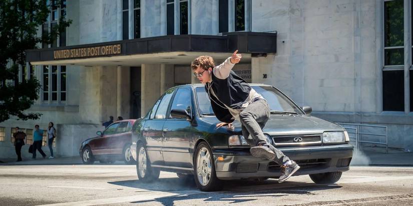 Ansel Elgort as Baby narrowly avoids a car in Baby Driver.