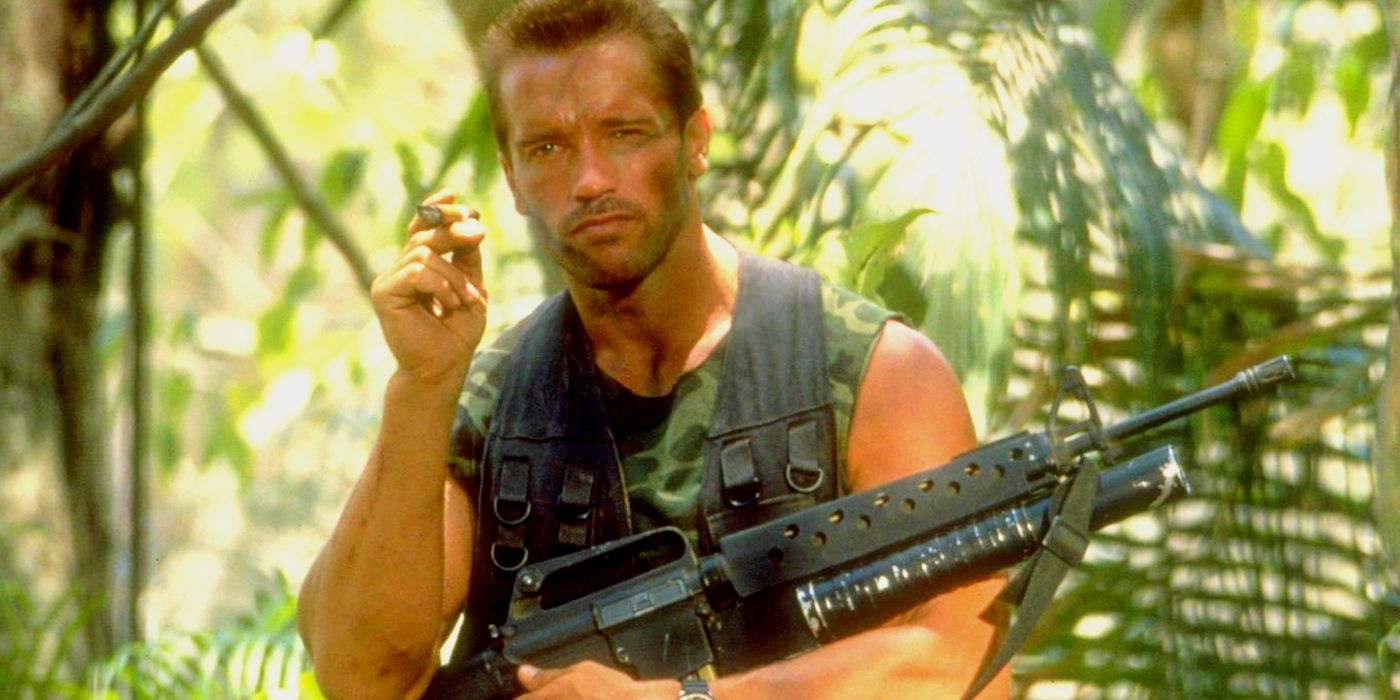 Arnold Schwarzenegger as Dutch with a gun in his lap in Predator