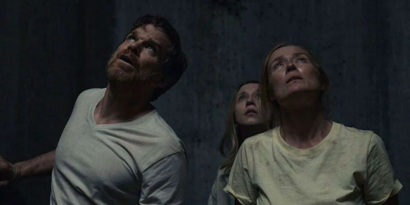 Brad (Michael C. Hall), Laurie (Taissa Farmiga), and Anna (Jennifer Ehle) covered in grime and looking up from the hole in John and the Hole.