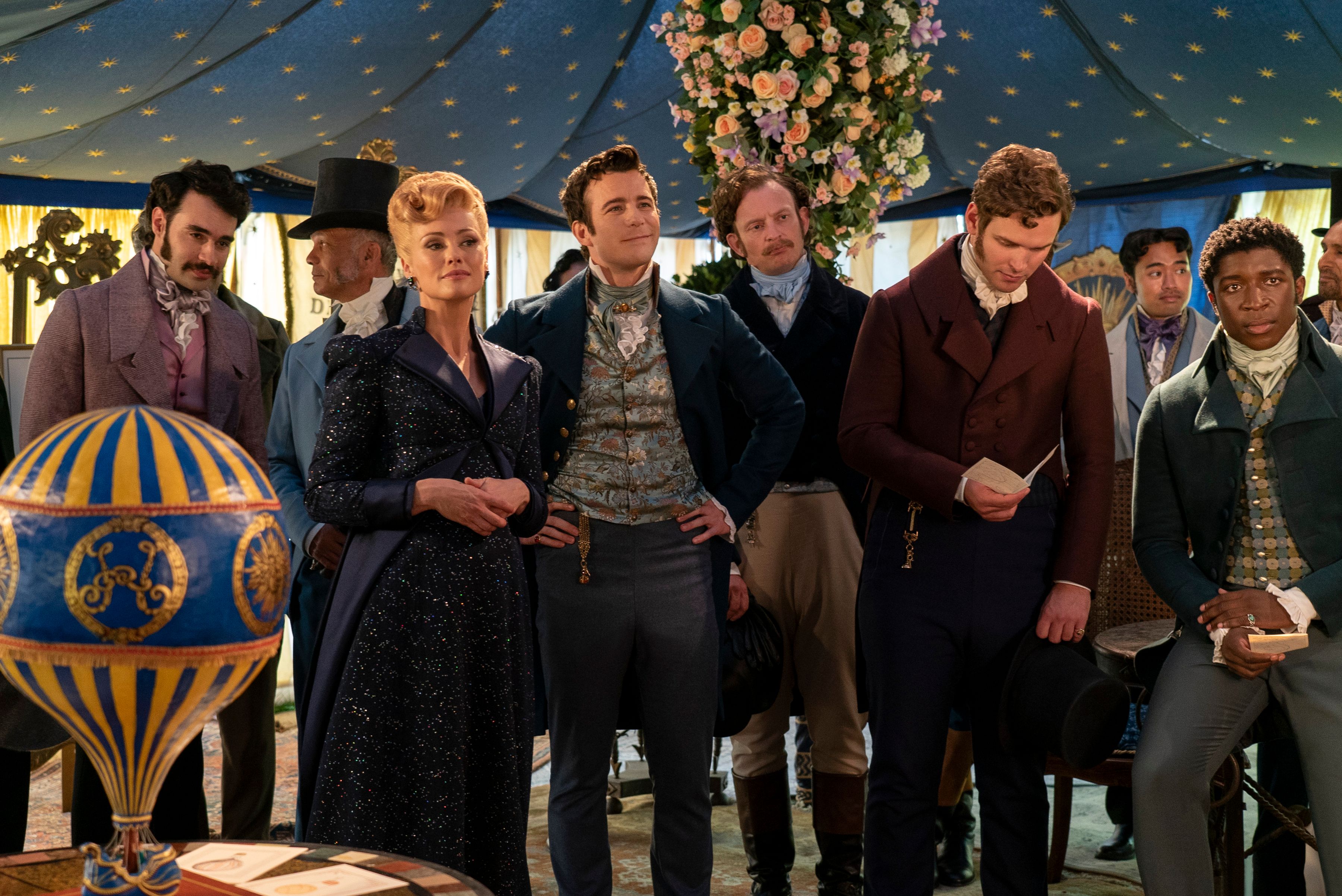 Luke Thompson as Benedict Bridgerton standing with Hannah New as Lady Tilley Arnold underneath a tent in Bridgerton season 3 episode 3