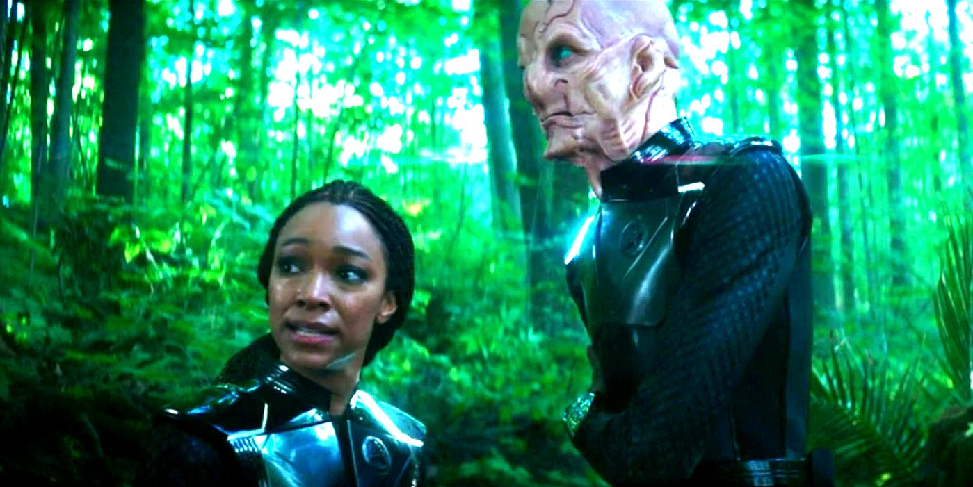 Burnham and Saru looking tense in the woods on Lyrek in Star Trek Discovery