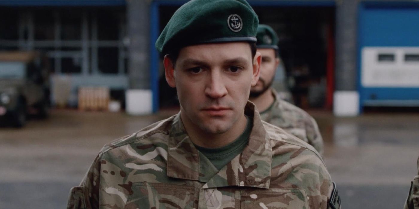 Callum McGowan olha para baixo em um uniforme do exército em Between the Devil and The Deep Blue Sea