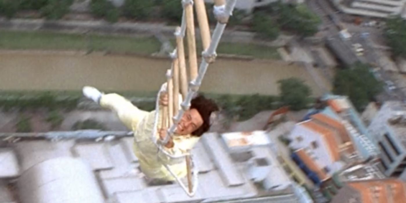 Jackie Chan hanging from a ladder in Police Story 3