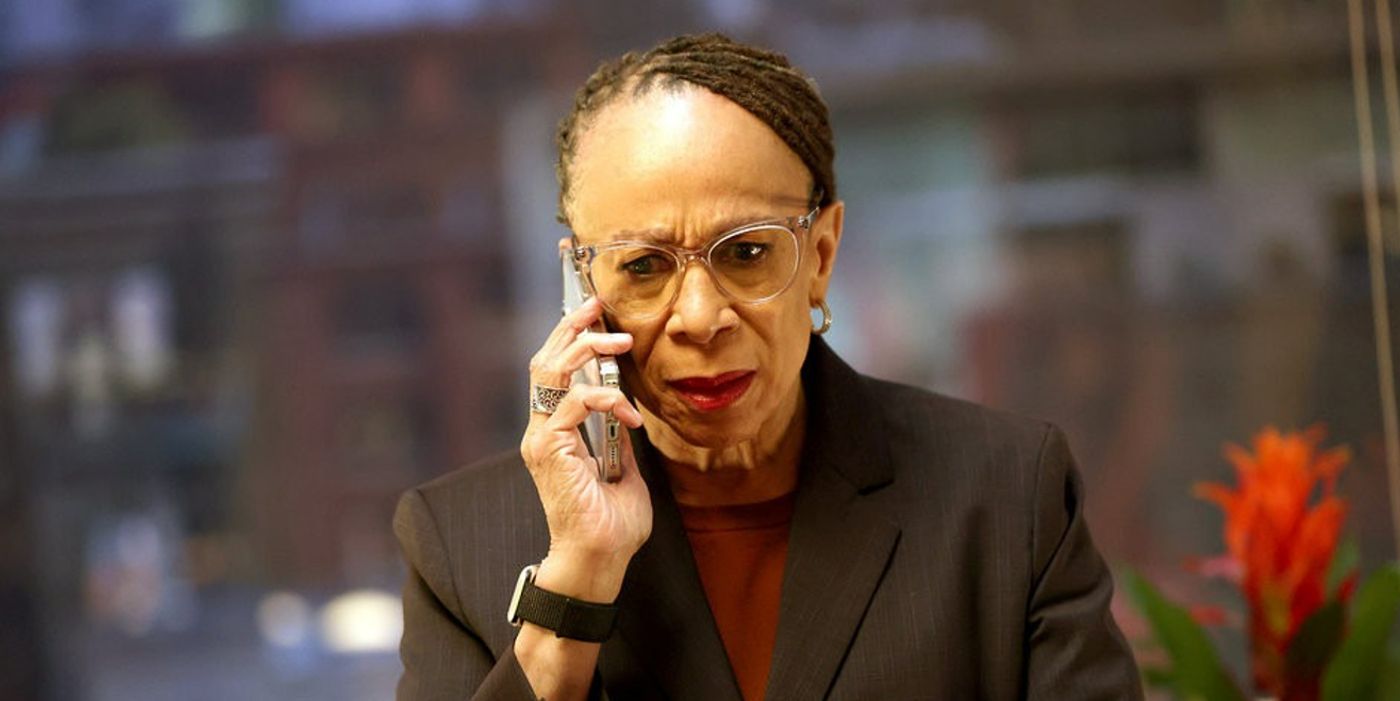 Chicago Med's Sharon Goodwin (S. Epatha Merkerson) looking shocked by news received on the phone in season 9