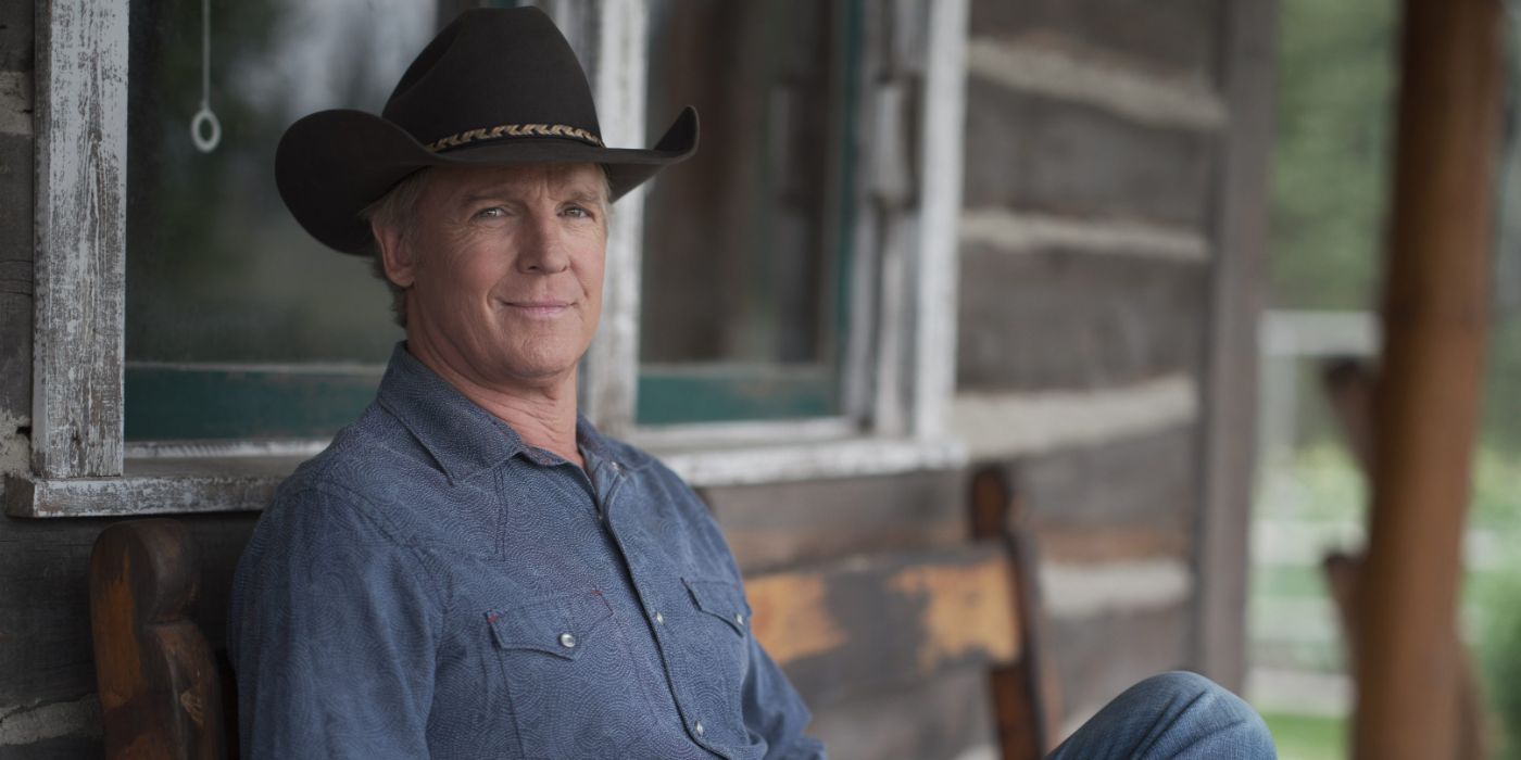 Chris Potter as Tim Fleming sitting on a porch and smiling in Heartland.