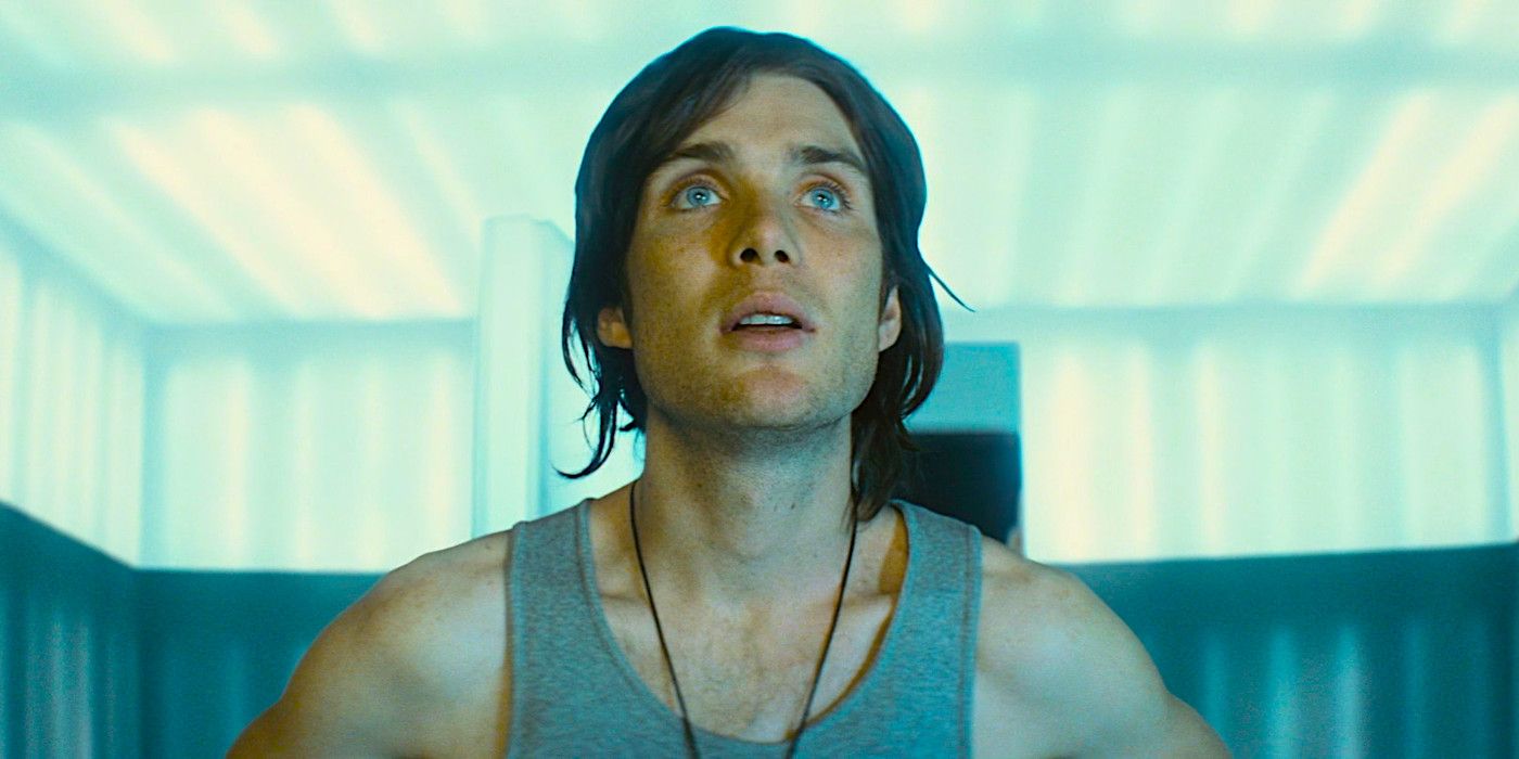 Cillian Murphy gazing upward with curiosity, bright light flooding his face in a scene from Sunshine