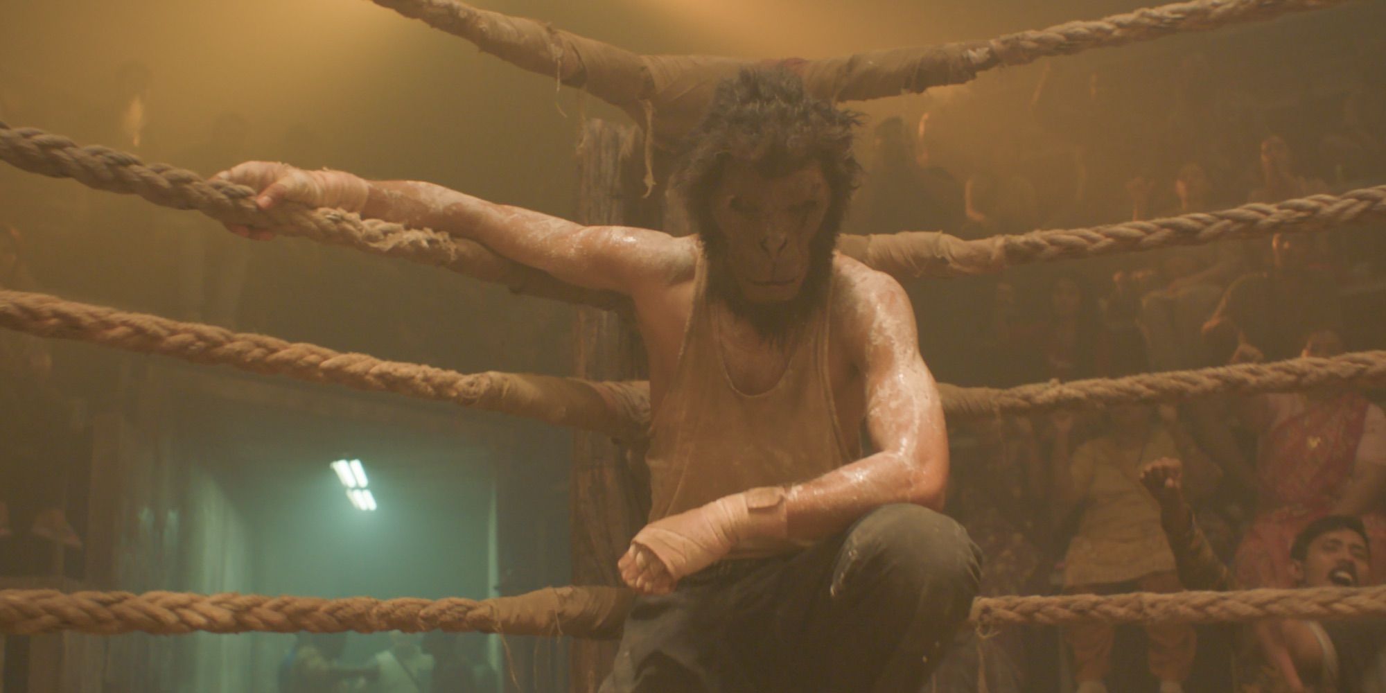 Dev Patel wearing a monkey mask while in the ring in Monkey Man
