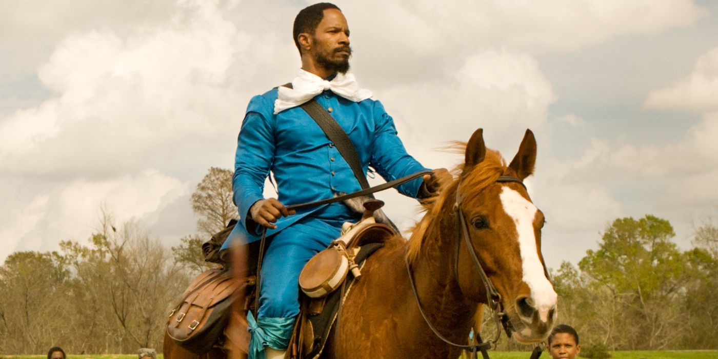 Django (Jamie Foxx) riding a horse in a blue outfit in Django Unchained.