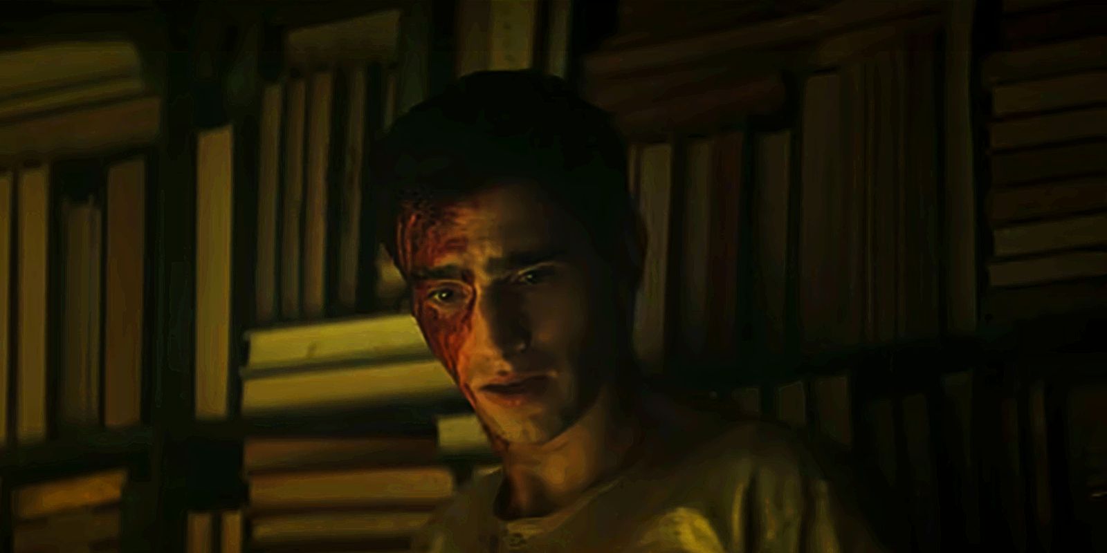 Edwin has blood on his face while standing in front of a bookcase in Dead Boy Detectives